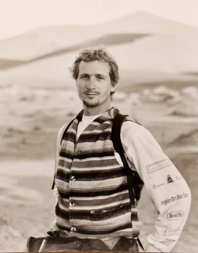 Sean Lawson standing in a desert landscape with a pack on his back