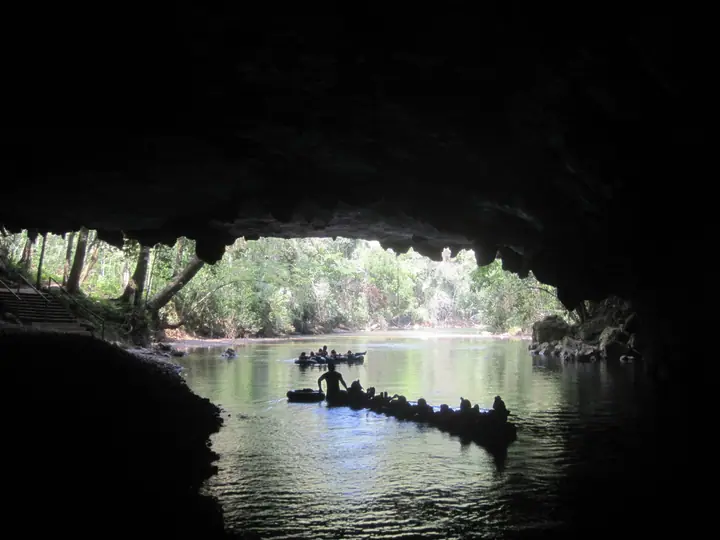The mouth of a cave opening onto the river