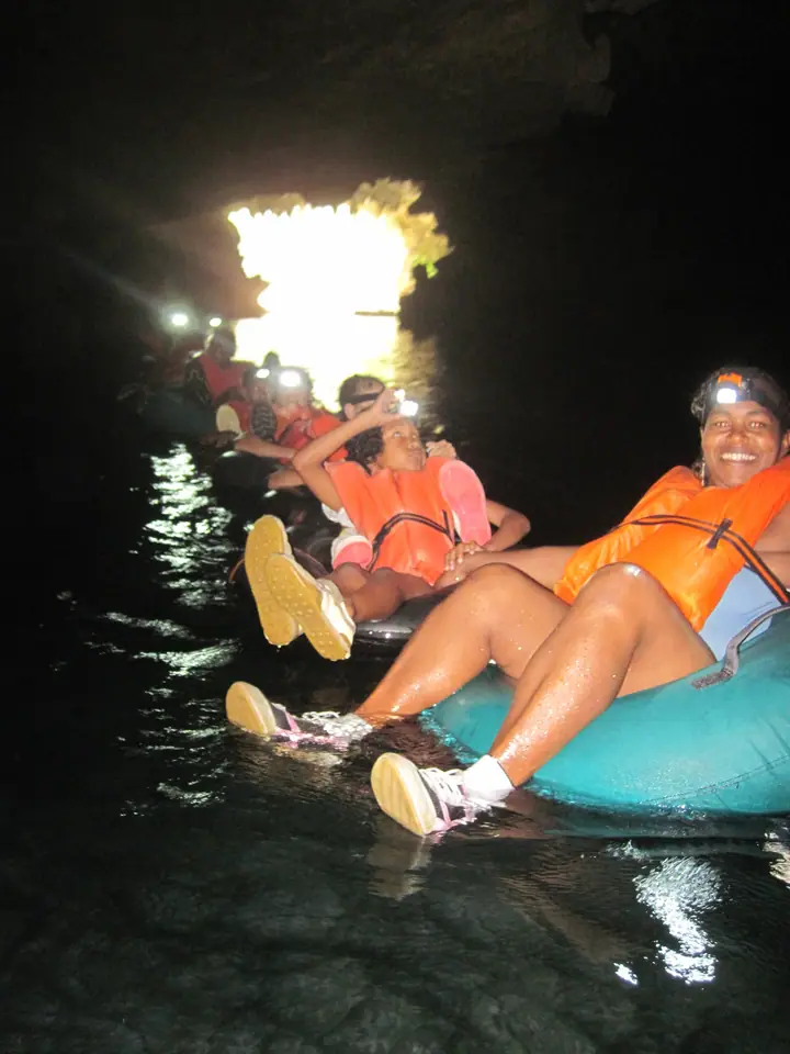 Floating through a dark cave on inner tubes