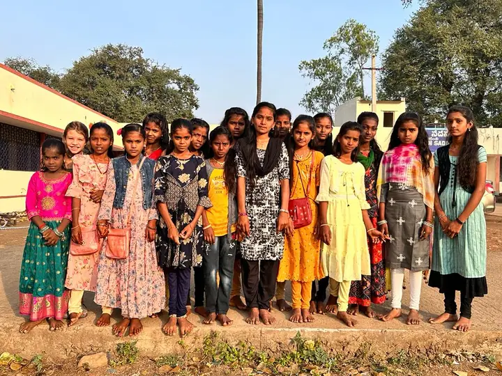 A group of smiling students lined up for a group portrait