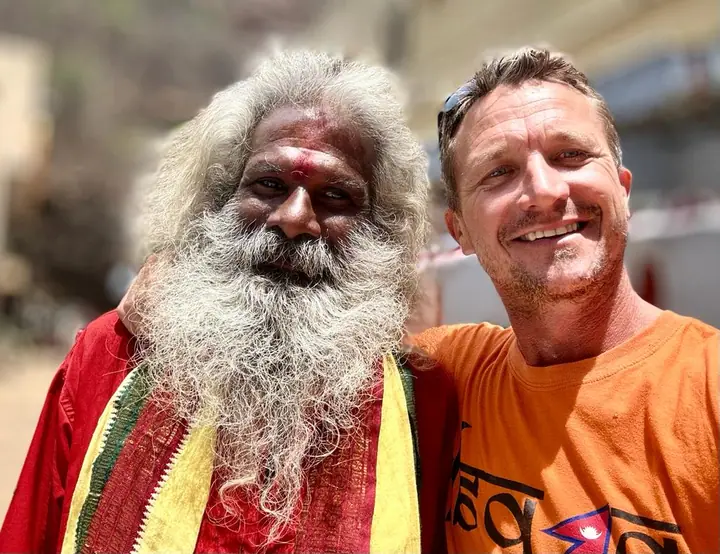 A smiling selfie with a white-bearded local man