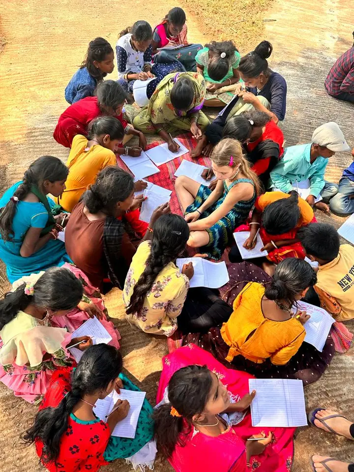 Students drawing together on the floor