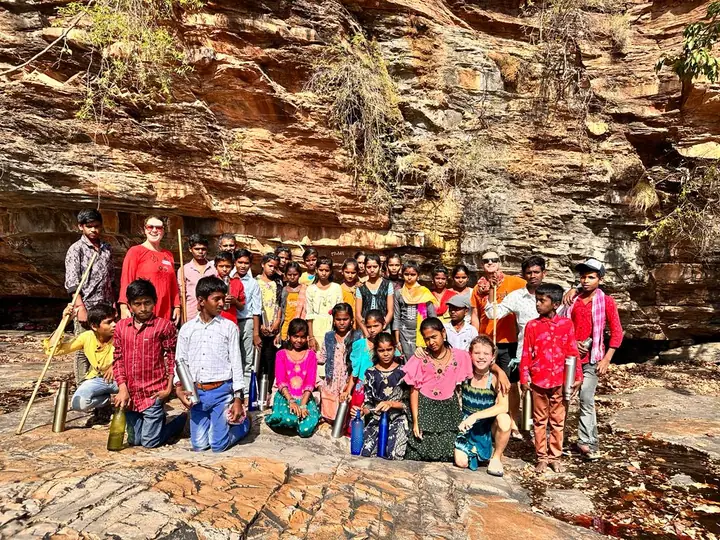 Students gathered on the rocky hillside