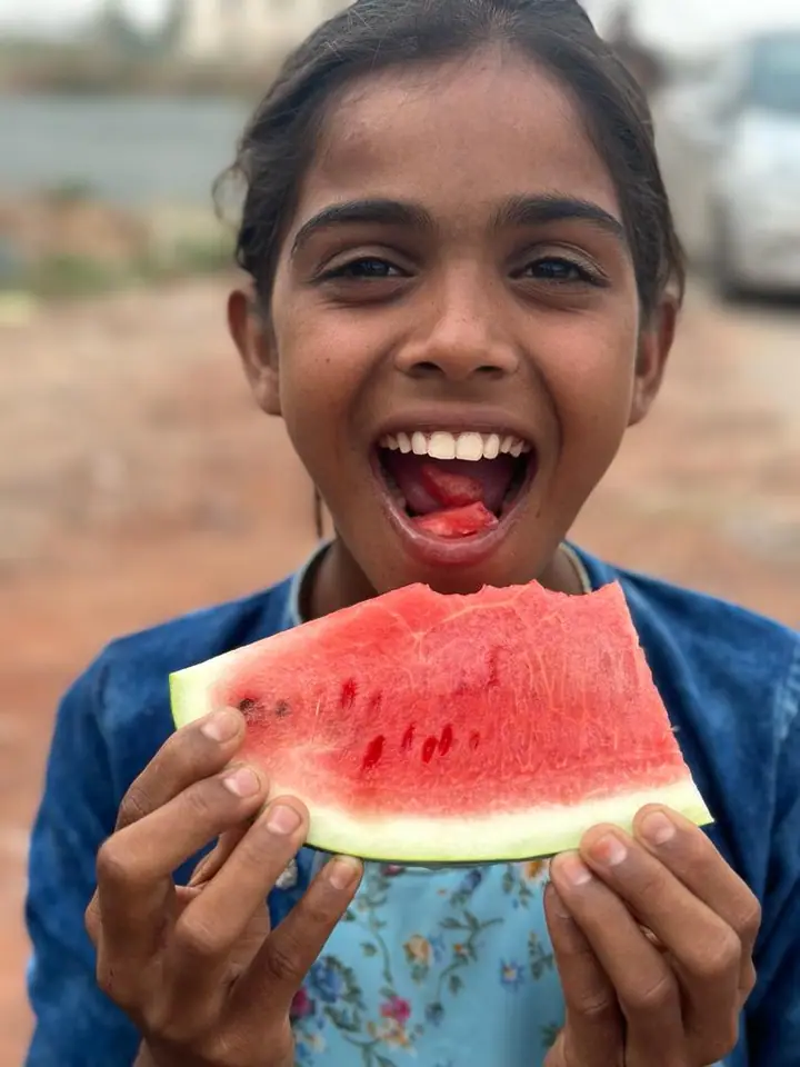 A student enjoying a slice of watermelon