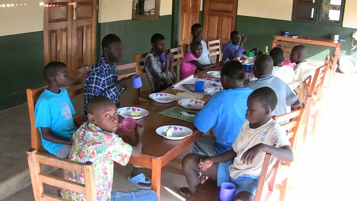 Students sharing a meal around a long table